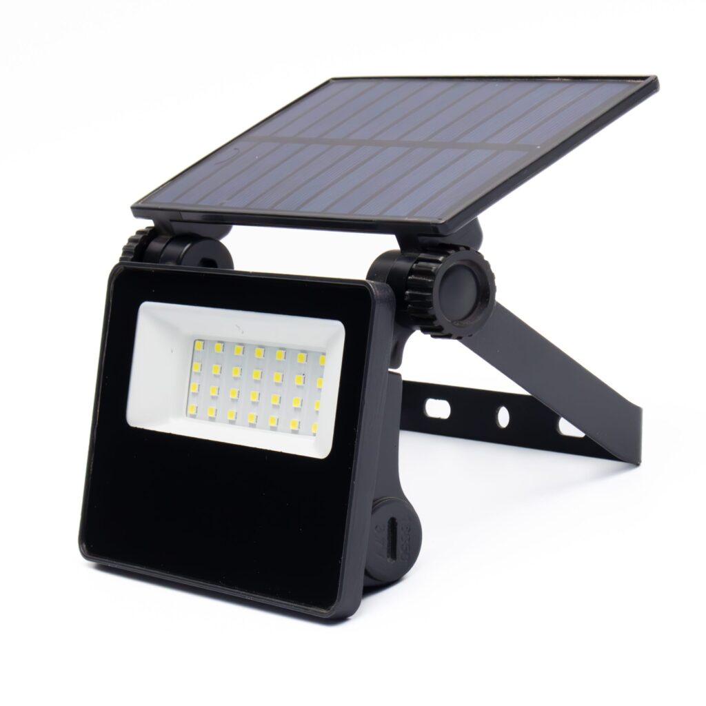 Admore A-SPL01 2W solar-powered LED outdoor wall flood light — adjustable polycrystalline solar panel on hinge, ~30 SMD LED panel behind tempered glass diffuser, black ABS+aluminum housing with wall-mount bracket